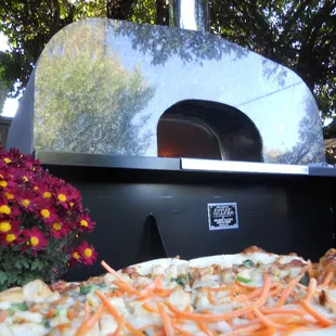 a pizza sitting on a table outside