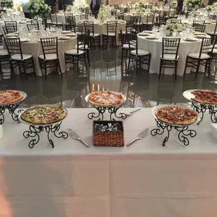 a variety of pizzas on a table