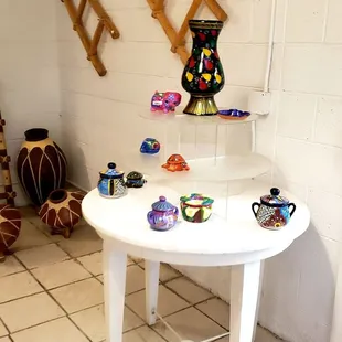 a white table with vases on it