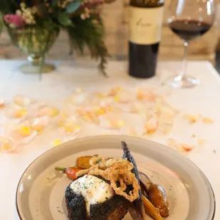 a plate of food and a bottle of wine