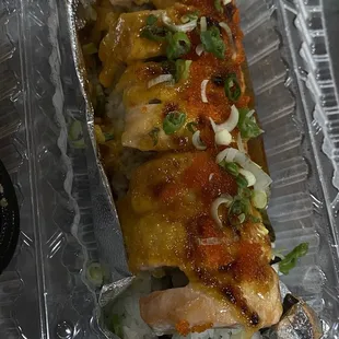 a sushi roll in a plastic container