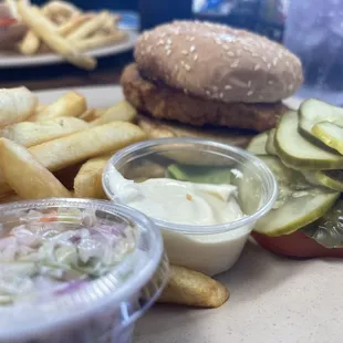 Chicken sandwich deluxe with fries and coleslaw.