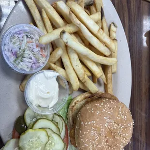 Chicken sandwich deluxe with fries and coleslaw.