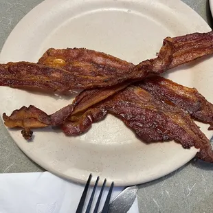 a plate of bacon on a table