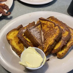 a plate of french toast and bacon