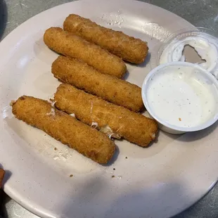 a plate of fried fish sticks and bacon