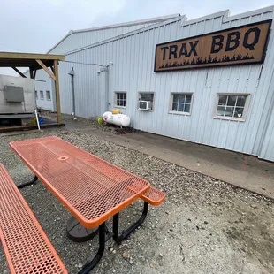 a picnic table in front of a building