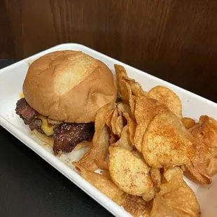 Saddle Up burger ($16), to go. Brisket &amp; short rib patty, aged cheddar, crispy shallots, candied bacon, charred onion aioli, and bbq sauce.