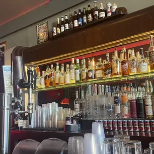 a bar with a rainbow flag hanging above the bar