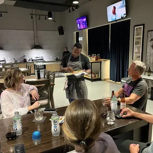 Tre giving feedback on the dish and people preparing it.