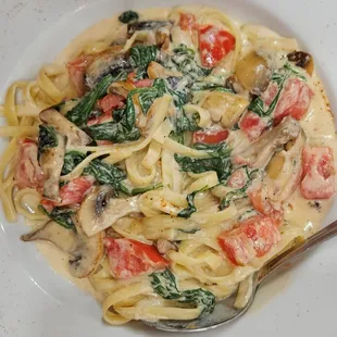 Fettuccine with Fresh Tomatoes, Spinach and Mushrooms in a cream sauce with a touch of Old Bay.