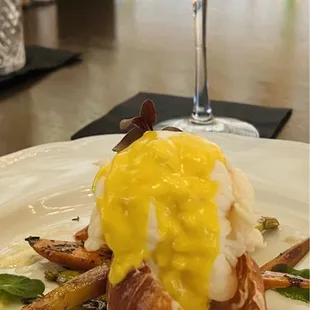 Champagne poached South African lobster tails over root vegetables (instead of risotto) with infused truffle butter and saffron sauce.