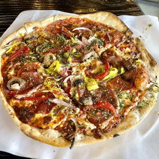 "Extra Fancy" flatbread pizza with roasted peppers, onions, and Italian meats