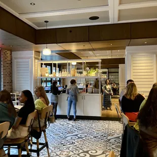 people sitting at tables in a restaurant