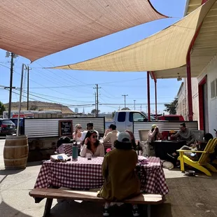 a group of people sitting at a picnic table