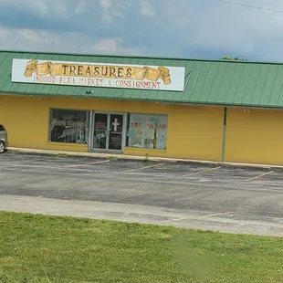 Yellow building with green roof.