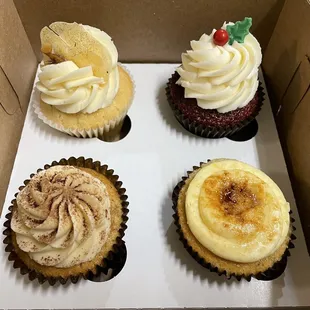 four cupcakes in a box