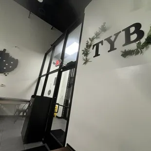 Inside facing entrance. Tyb means tasty :)