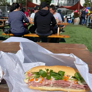 Combination banh mi sandwich packed with meat and pickled veggies