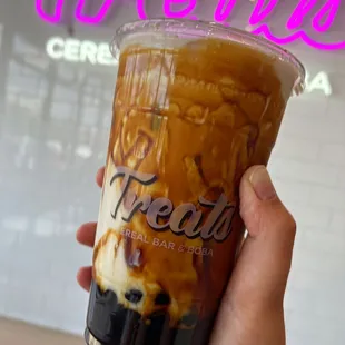a hand holding a cup of coffee