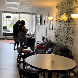two people walking through the room