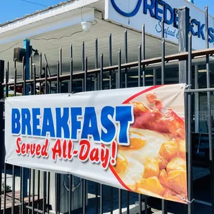 a sign for breakfast served all day