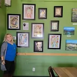 a woman standing in front of a green wall
