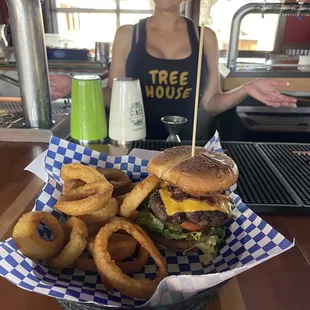 a woman standing behind a basket of food