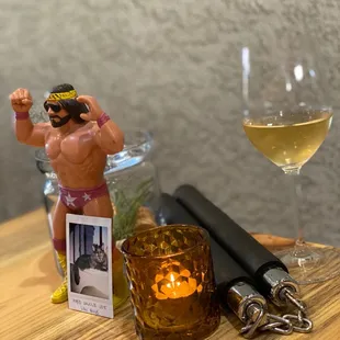 a glass of wine and a figurine