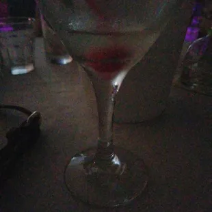 a wine glass with a red liquid in it