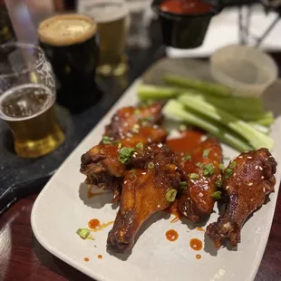 a plate of chicken wings and celery