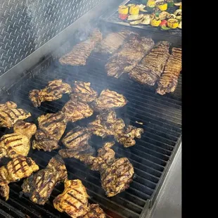 a grill with meat cooking on it