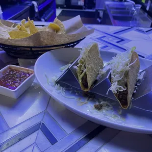Ground beef tacos; chips and bland salsa.