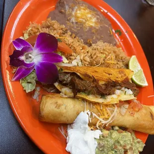 Combination plate with flour flauta and quesabirria.