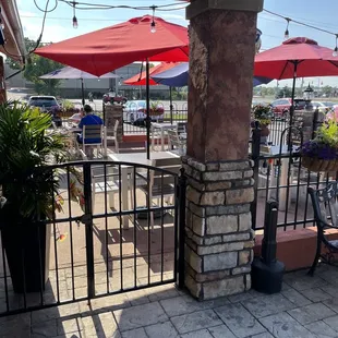 a patio with tables and umbrellas