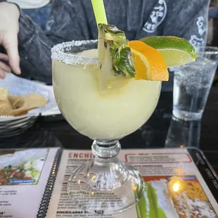 a man sitting at a table with a drink