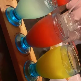 a row of glasses filled with drinks