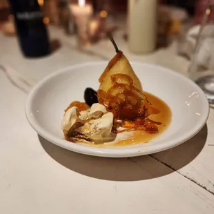 Poached pear with dulce de leche ice cream.