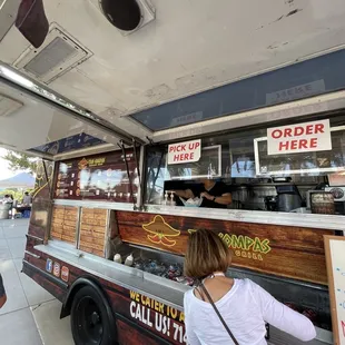 a woman ordering food from a food truck