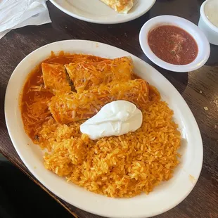 Chicken Enchiladas with rice and sour cream and a Cheese Quesadilla