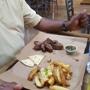 Sirloin cooked medium with green sauce and small fries