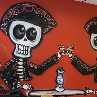 two skeletons sitting at a table