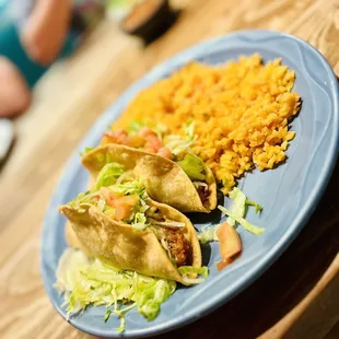 a plate of tacos and rice