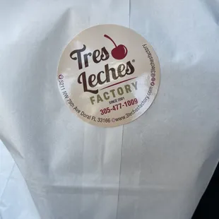 a white bag with a cherry on it