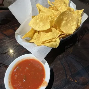 a bowl of chips and a bowl of salsa