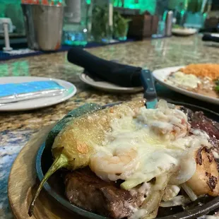 Ohio Steak-  Grilled Sautéed onions, Jalapeno pepper, shrimp, melted Mozzarella cheese and a rib eye steak.