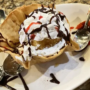 a dessert with whipped cream and chocolate sauce