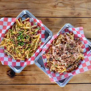 two trays of food on a wooden table