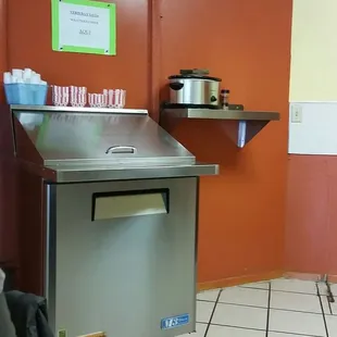 Salsa bar and crock w/stewed onions and peppers.