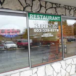 a restaurant window with a sign that says restaurant 3 rivers